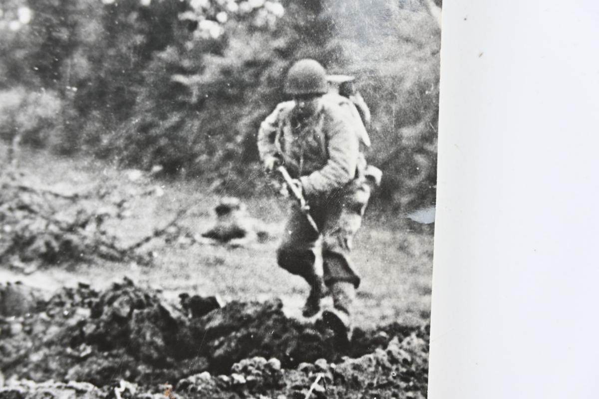 US WW2 Press Photo Normandy 'Americans Leap for Shell Hole in France'