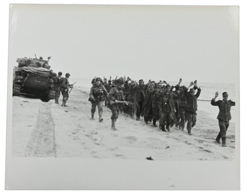 US WW2 Press Photo 'Prisoners of War on the Normandy Beach'