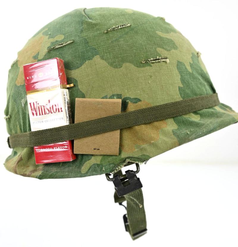 US Vietnam War Infantry helmet with camouflage cover and attached content